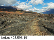 Lava field at Tolbachik volcano, after eruption in 2012 on background Big Udina volcano and Plosky Tolbachik volcano, Klyuchevskaya Group of Volcanoes (2016 год). Редакционное фото, фотограф Юлия Машкова / Фотобанк Лори