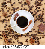 Cup of coffee, chocolate, sugar, spices and coffee beans on a wooden background. Стоковое фото, фотограф Феликс Хромых / Фотобанк Лори