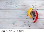 Red and yellow, sweet pepper chili on a light background. View from above. Free place for inscriptions on the left. Стоковое фото, фотограф Татьяна Дубчук / Фотобанк Лори