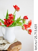 Tulips bouquet in white vase on wooden rustic chair. Стоковое фото, фотограф Дарья Петренко / Фотобанк Лори