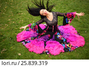 Young woman in beautiful skirt zingara poses on green lawn outdoor. Стоковое фото, фотограф Losevsky Pavel / Фотобанк Лори