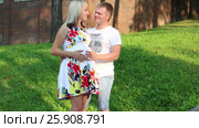 Pregnant woman and happy man pose in summer green park. Стоковое видео, видеограф Светлана Додух / Фотобанк Лори