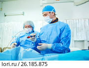 Interventional cardiology. Male surgeon doctor at operation. Стоковое фото, фотограф Дмитрий Калиновский / Фотобанк Лори