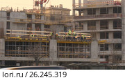 Construction site in the evening. The brigade makes the embedded elements of metal structures. Beautiful sunny evening. Стоковое видео, видеограф Игорь Усачев / Фотобанк Лори