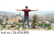 Young male on the lookout at the background of Tbilisi. Стоковое видео, видеограф Виктор Аллин / Фотобанк Лори