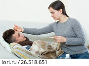 Concerned mother giving mixture to son with quinsy. Стоковое фото, фотограф Яков Филимонов / Фотобанк Лори