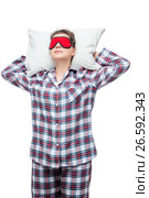 Sleeping woman on a pillow in plaid pajamas with a mask in front of her eyes isolated. Стоковое фото, фотограф Константин Лабунский / Фотобанк Лори