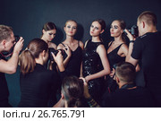 Photographers paparazzi take photos of women in cocktail dresses on dark background. Стоковое фото, фотограф Женя Канашкин / Фотобанк Лори