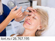 Mature female receiving cosmetic injection. Стоковое фото, фотограф Яков Филимонов / Фотобанк Лори