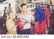 Couple choosing erotic lingerie in sex shop. Стоковое фото, фотограф Яков Филимонов / Фотобанк Лори