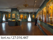 KOSTROMA, RUSSIA - MAY 06, 2017: Collection of ancient Russian orthodox icons in the Ipatiev Monastery. Woman looks at the icons at an exhibition. Редакционное фото, фотограф Юлия Бабкина / Фотобанк Лори