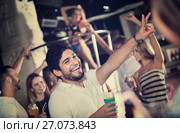 positive male joying and thumbs up on party in the club with coc. Стоковое фото, фотограф Яков Филимонов / Фотобанк Лори