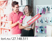 woman and man bayers choosing long rubber phallus in the sex shop. Стоковое фото, фотограф Яков Филимонов / Фотобанк Лори