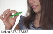 Beautiful cheerful teen girl playing with green fidget spinner on white background stock footage video. Стоковое видео, видеограф Юлия Машкова / Фотобанк Лори