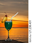 Glass of drink is on a beach table. Стоковое фото, фотограф М / Фотобанк Лори