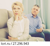 upset middle-aged couple quarreling at home with each other. Стоковое фото, фотограф Яков Филимонов / Фотобанк Лори