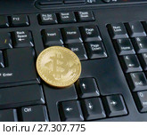Golden bitcoin on black keyboard closeup. Стоковое фото, фотограф Курганов Александр / Фотобанк Лори