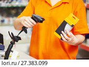Seller with barcode scanner in shop. Стоковое фото, фотограф Дмитрий Калиновский / Фотобанк Лори