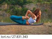 Young woman is practicing yoga near river. Стоковое фото, фотограф Volodymyr Melnyk / PantherMedia / Фотобанк Лори