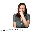 A woman on a white background clamps her nose and wrinkled, as if from a hideous smell. Стоковое фото, фотограф Евгений Харитонов / Фотобанк Лори