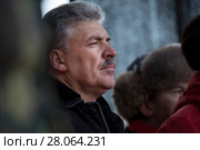 Павел Грудинин - кандидат в президенты РФ от КПРФ и Народно-патриотических сил России стоит на сцене во время митинга КПРФ на площади Революции в центре города Москвы, Россия 23 февраля 2018. Редакционное фото, фотограф Николай Винокуров / Фотобанк Лори