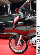 Part of black bike for cortege, car are on red carpet in exhibition. Стоковое фото, фотограф Losevsky Pavel / Фотобанк Лори