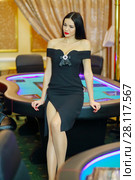 Young beautiful brunette poses near poker electronic table in luxury casino. Стоковое фото, фотограф Losevsky Pavel / Фотобанк Лори