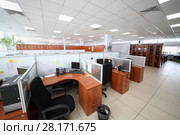 MOSCOW, RUSSIA - APR 25, 2016: Big office with partitions workplaces and plants in Moscow city telephone network. Редакционное фото, фотограф Losevsky Pavel / Фотобанк Лори
