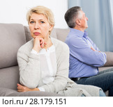 aggrieved middle-aged couple quarreling at home with each other. Стоковое фото, фотограф Яков Филимонов / Фотобанк Лори