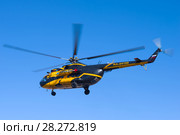ST. PETERSBURG, RUSSIA - APRIL 07, 2018: The helicopter Mi-8TV (RA-24100) of the airline Alliance Avia AON flying in the blue sky. Редакционное фото, фотограф Виктор Карасев / Фотобанк Лори