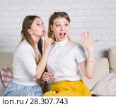 Two young girls are sitting on the couch. Стоковое фото, фотограф Типляшина Евгения / Фотобанк Лори