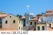 Herceg Novi, Montenegro - July 8, 2015: Old town gate with the small clocktower surrounded by old houses. Редакционное фото, фотограф Papoyan Irina / Фотобанк Лори