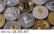 A pattern from different coins of crypto currency on a dark background. Slow motion. 1080p Full HD video. Стоковое видео, видеограф Ярослав Данильченко / Фотобанк Лори