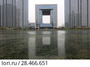 TIANJIN, CHINA - APRIL 8, 2017. A modern building along the Haihe River in Tianjin, China. Редакционное фото, фотограф Яна Королёва / Фотобанк Лори