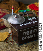 Close-up of donation box in temple, Krong Siem Reap, Siem Reap, Cambodia. Стоковое фото, фотограф Keith Levit / Ingram Publishing / Фотобанк Лори