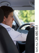 The young man behind the wheel driving car. Стоковое фото, фотограф Kirill Kedrinskiy / Ingram Publishing / Фотобанк Лори