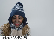 Portrait of african woman on gray background wearing woolen accessories. Стоковое фото, фотограф Kirill Kedrinskiy / Ingram Publishing / Фотобанк Лори