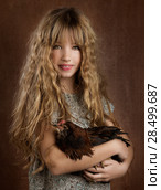 Children fashion farmer girl holding hen in retro vintage background. Стоковое фото, фотограф Tono Balaguer / Ingram Publishing / Фотобанк Лори