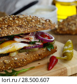 Bacon and fried eggs sandwich on the kitchen table. Стоковое фото, фотограф Olena Mykhaylova / Ingram Publishing / Фотобанк Лори