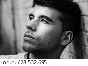 Close-up of young man with blue eyes in the street. Model of fashion in urban background. Стоковое фото, фотограф Javier Sánchez Mingorance / Ingram Publishing / Фотобанк Лори