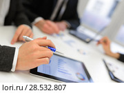 Close-up of a modern business team using tablet computer to work with financial data. Стоковое фото, фотограф Javier Sánchez Mingorance / Ingram Publishing / Фотобанк Лори