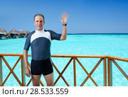 The sports man in a suit for a snorkeling on sundeck of a house over the sea. Maldives. Стоковое фото, фотограф Куликов Константин / Фотобанк Лори