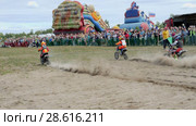 June 10, 2018 Russian Federation, Bryansk region, Ivot - Extreme sports, cross motocross. The motorcyclist enters the turn on the race track. Dirt is flying from under the wheels. The machine overcomes obstacles. Athletes fly through the air. Children's sports. The child on a motorcycle participates in competitions. slow motion. Редакционное видео, видеограф Константин Мерцалов / Фотобанк Лори