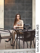 Happy beautiful girl using smart phone outdoors. Стоковое фото, фотограф Restyler Viacheslav / Фотобанк Лори
