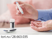medicine, diabetes, glycemia, health care and people concept - close up of male finger with test stripe. Стоковое фото, фотограф Майя Крученкова / Фотобанк Лори