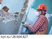 worker with demolition hammer breaking interior wall. Стоковое фото, фотограф Дмитрий Калиновский / Фотобанк Лори