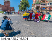 Болельщики  с флагами  в городе Москве на Васильевском спуске во время Чемпионата мира по футболу FIFA 2018, Россия. Фото на память. Редакционное фото, фотограф Виктор Тараканов / Фотобанк Лори
