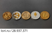 Five different coins of crypto-currencies presented in a row on a dark background. Virtual money concept. Top view. Стоковое фото, фотограф Ярослав Данильченко / Фотобанк Лори