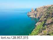 Lake Baikal in the summer. The northern extremity of Olkhon Island is Cape Khoboy. Small figures of tourists visiting the cliff - a natural landmark island. Стоковое фото, фотограф Виктория Катьянова / Фотобанк Лори