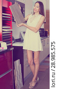 Positive woman looking for stylish kitchen fronts. Стоковое фото, фотограф Яков Филимонов / Фотобанк Лори